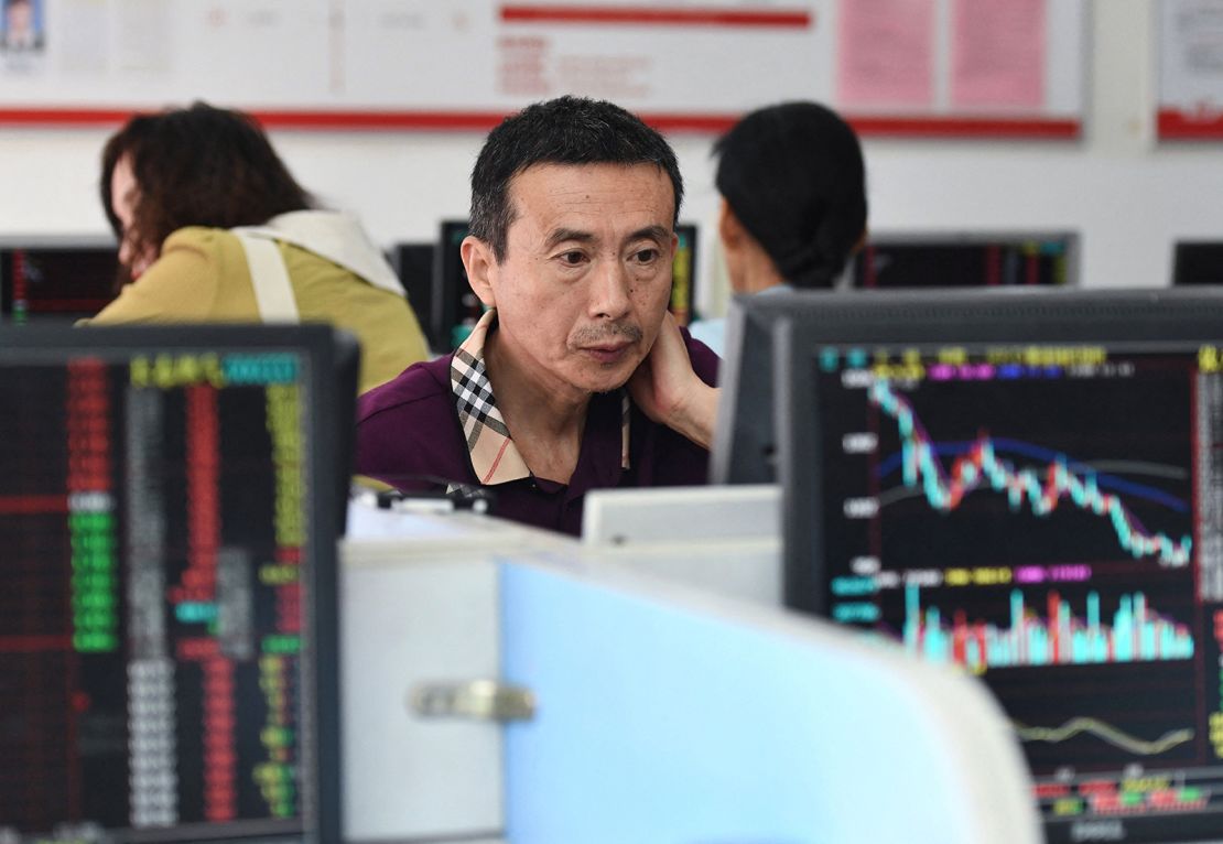 Investors monitor stock price movements at a securities company in Fuyang, in China's eastern Anhui province on August 28, 2023.