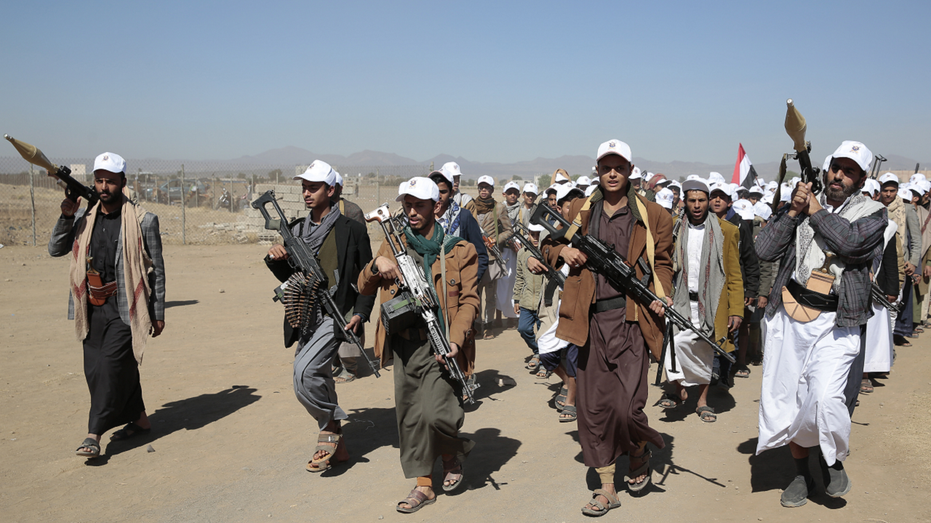 Houthi fighters march in Yemen