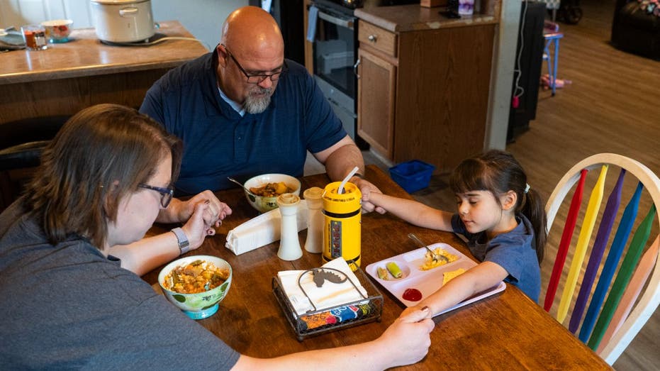 family sitting down to eat at home