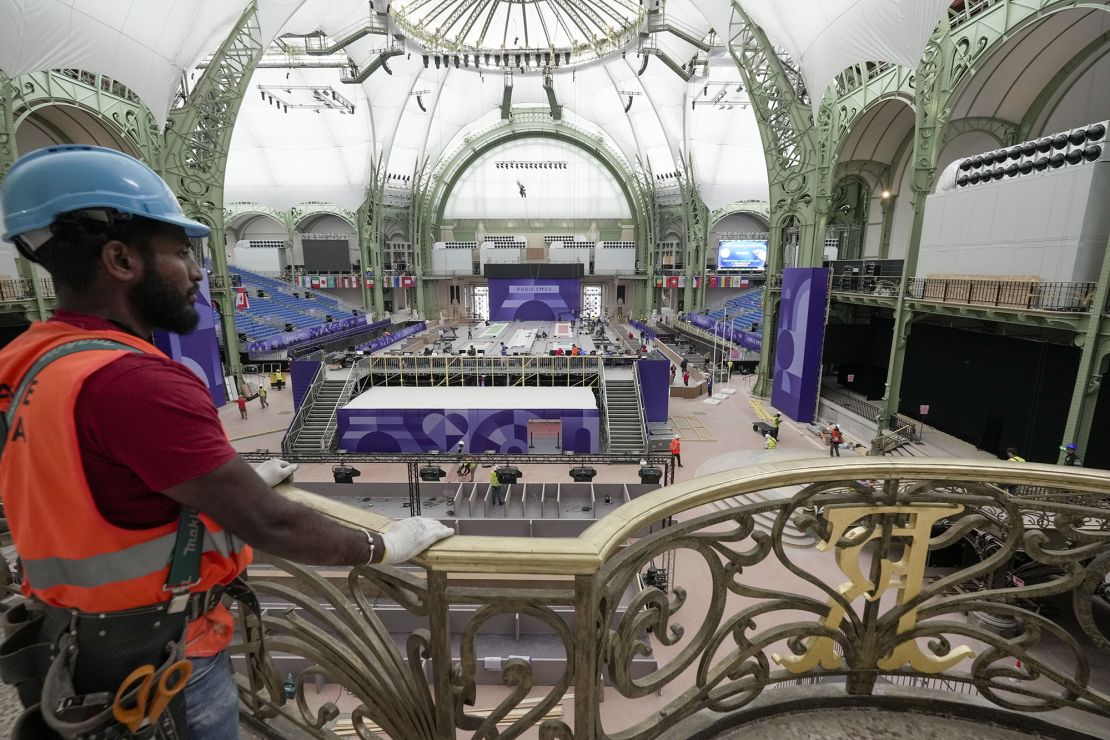 Workers apply the final touches at the Grand Palais, the venue that will host fencing and Taekwondo at the 2024 Summer Olympics, Tuesday, July 23, 2024, in Paris, France.