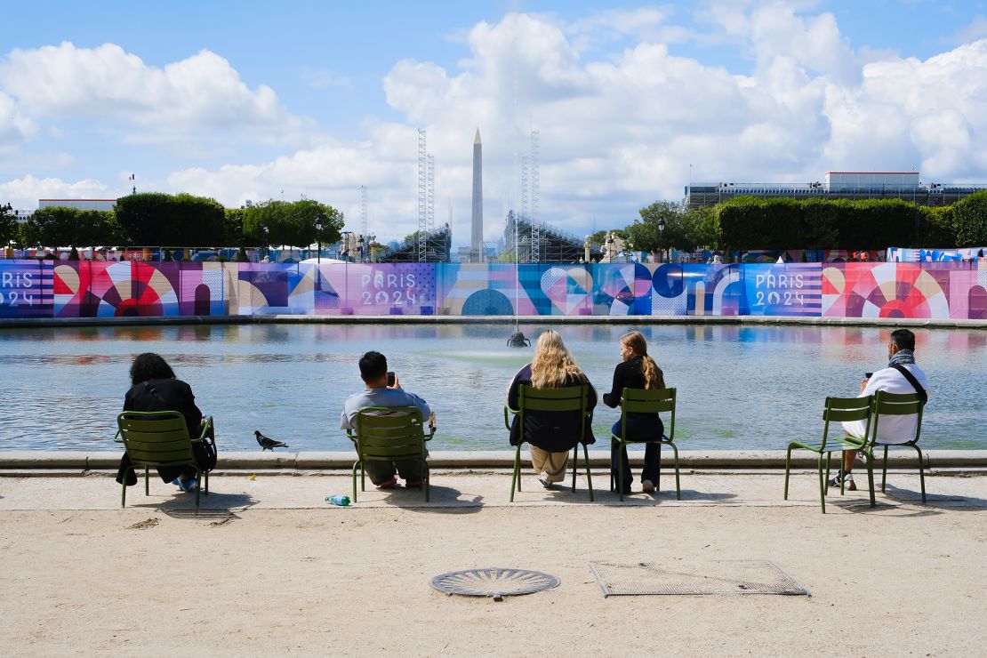 Tourists and Parisians are observing stands built for the Paris Olympic Games in the Tuileries garden.