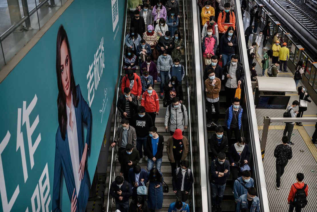 Commuters head to the subway platform during rush hour in Beijing in spring 2020.