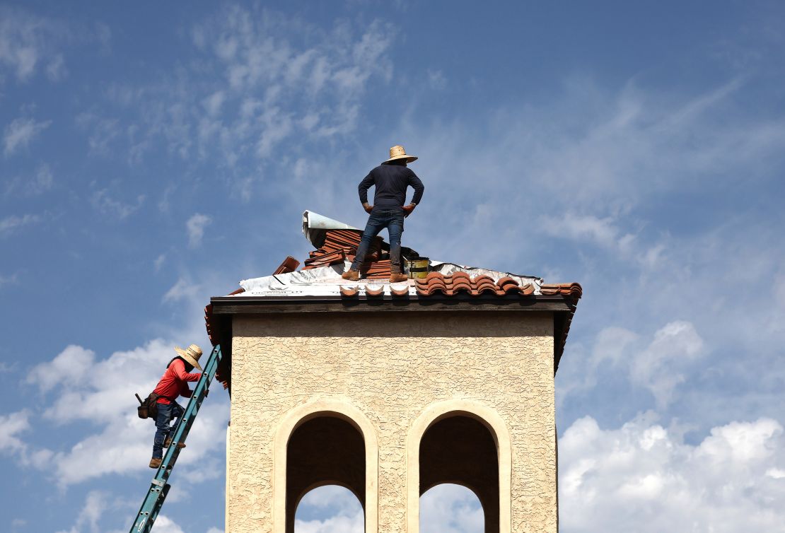 People work on the bell tower of a church amid the city's worst heat wave on record on July 26, 2023 in Phoenix, Arizona. While Phoenix endures periods of extreme heat every year, today is predicted to mark the 27th straight day of temperatures reaching 110 degrees or higher, a new record amid a long-duration heat wave in the Southwest. Extreme heat kills more people than hurricanes, floods and tornadoes combined in an average year in the U.S.