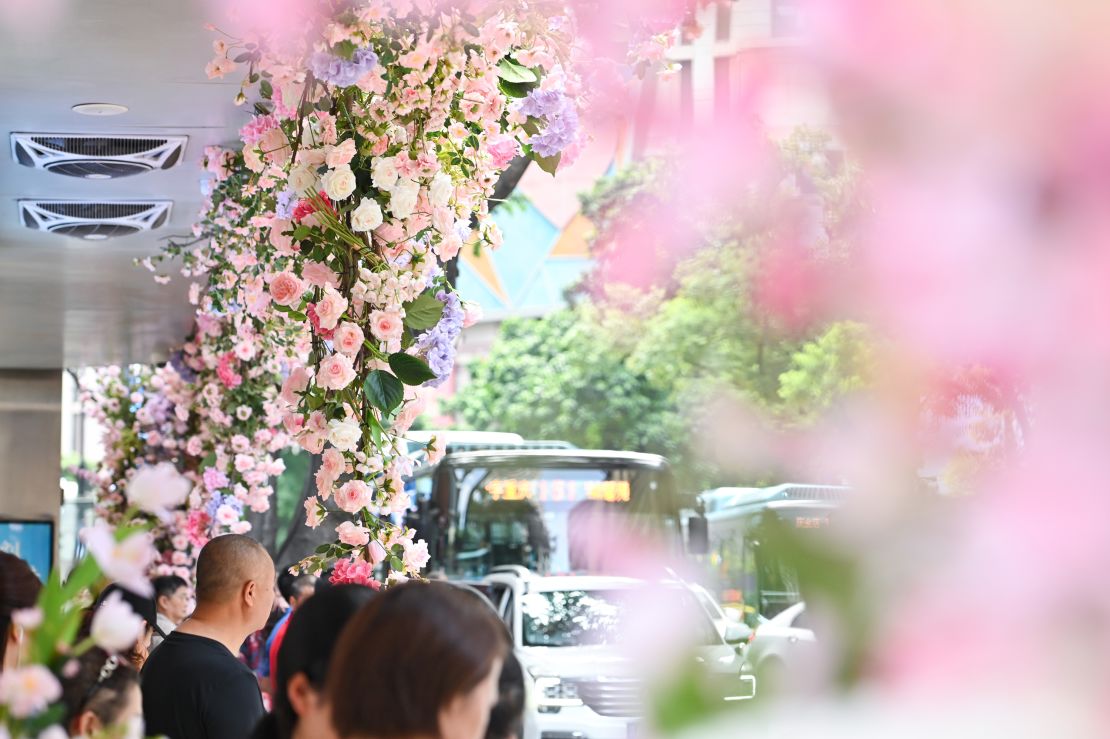 People take photos at a bus stop decorated with flowers during Qixi Festival, or Chinese Valentine's Day, on August 22, 2023 in Chongqing, China.