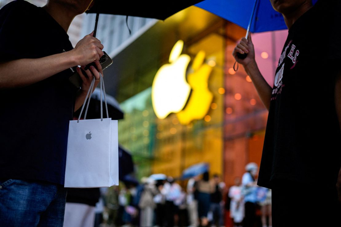 A man holds a bag with a new iPhone on September 22, 2023 when Apple's iPhone 15 went on sale in Shanghai, China .