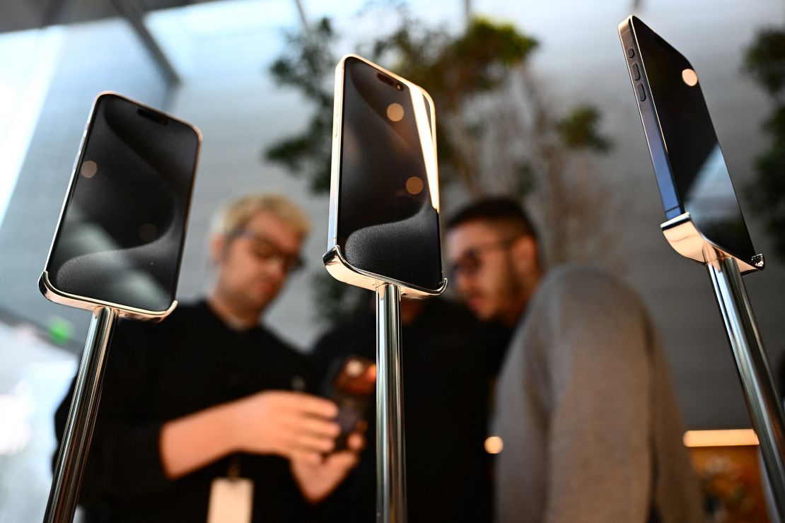 Apple iPhone 15 series devices are displayed for sale as a customer purchases an iPhone at The Grove Apple retail store on release day in Los Angeles, California, on September 22, 2023.